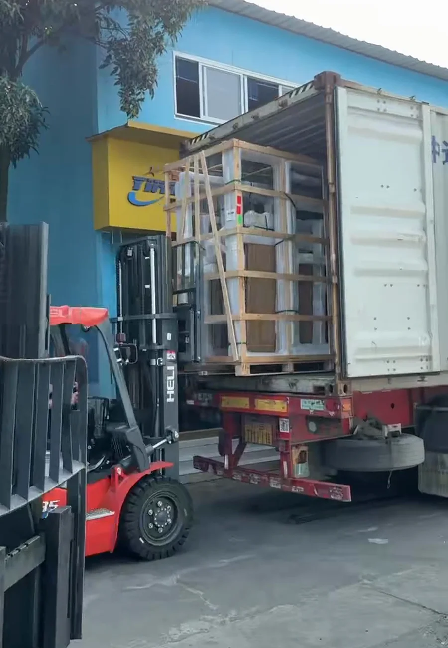 Two forklifts handling a reinforced export crate containing glass for Spain